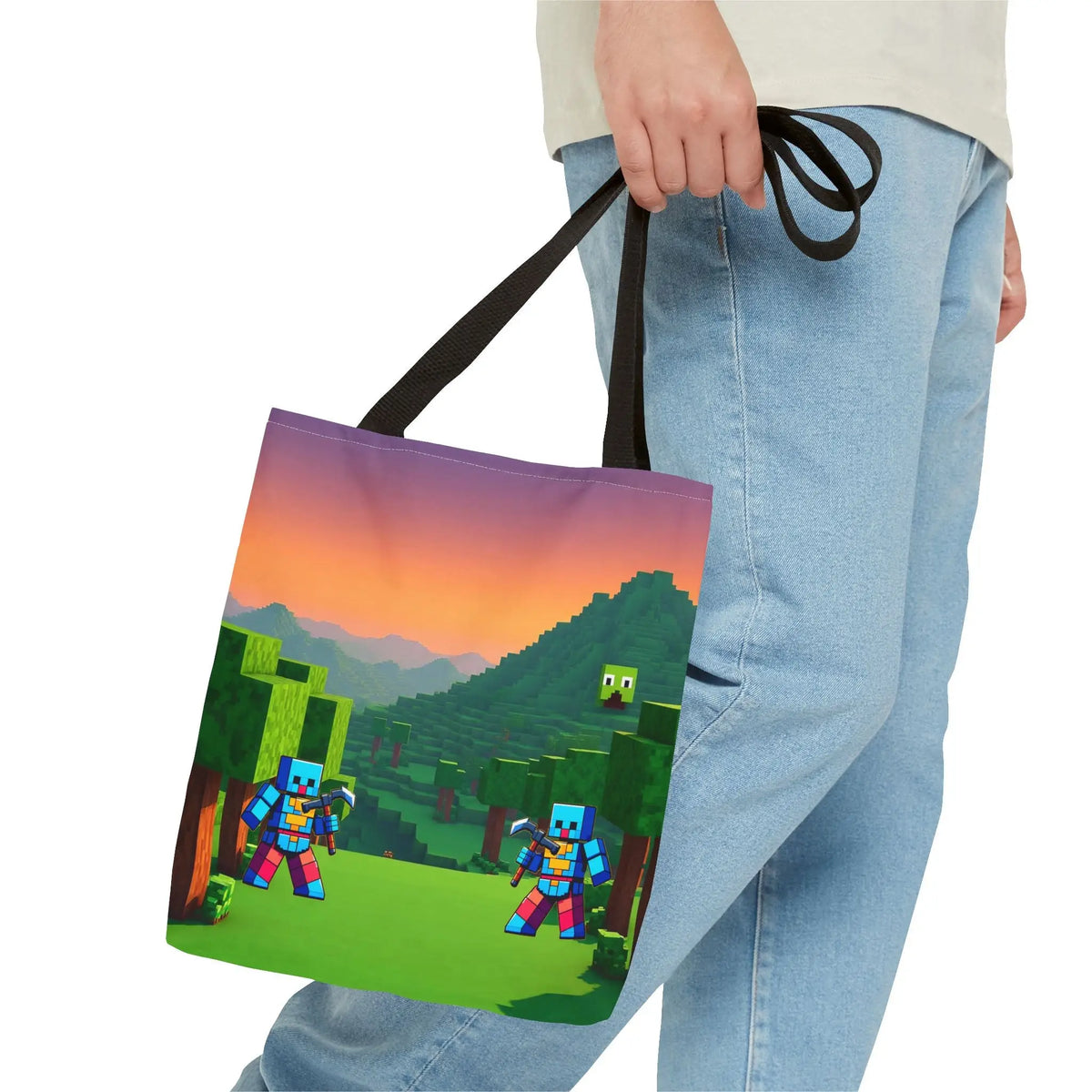 A minecraft inspired blocks tote bag for kids with pixelated characters, sunset landscape, and black fabric handles