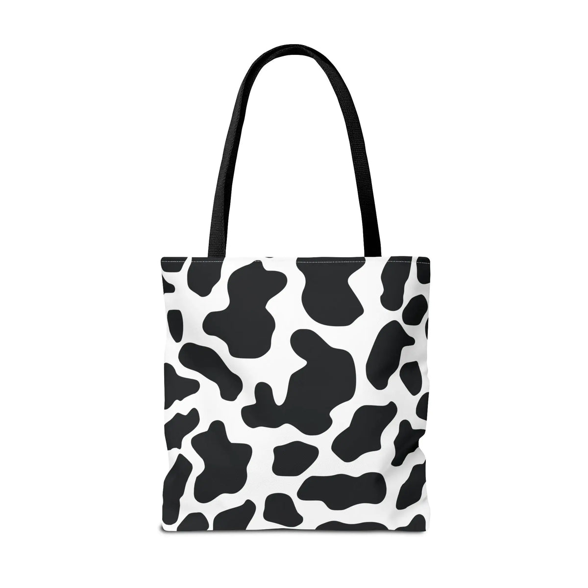 Black and white cow print tote bag with black fabric handles large reusable shopping and travel bag