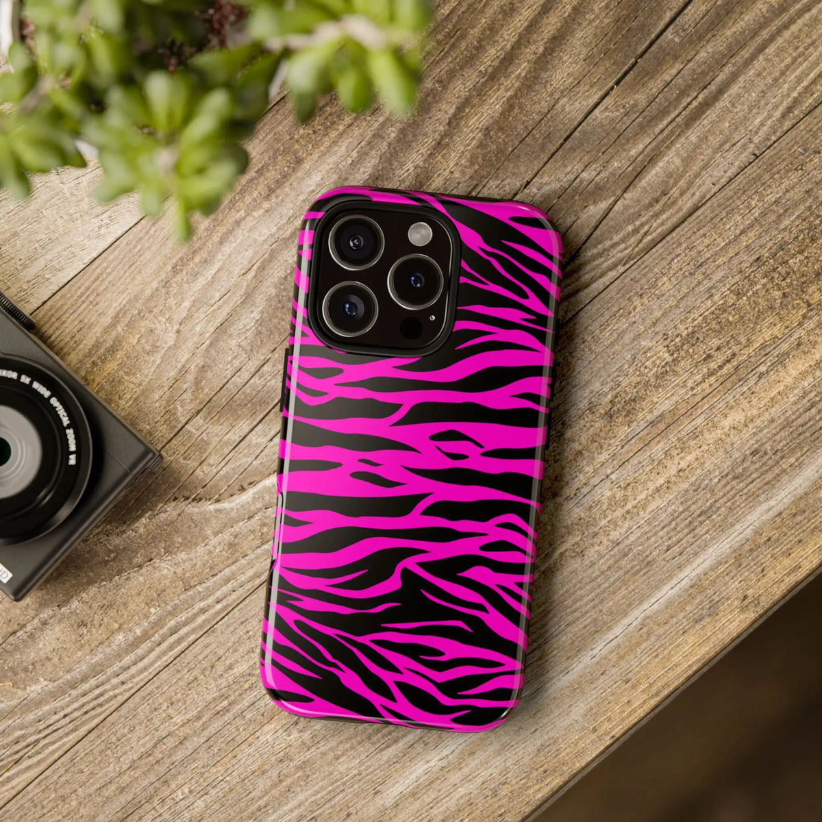 Back view of a vibrant pink and black zebra-striped tough phone case with a glossy finish for a tough phone
